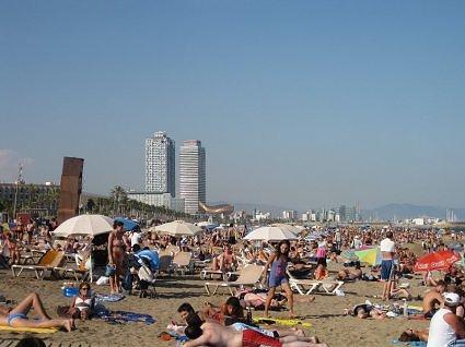 August- crowded beach in Barcelona called Barceloneta