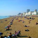 Sunning at Brighton Beach, East Sussex, England