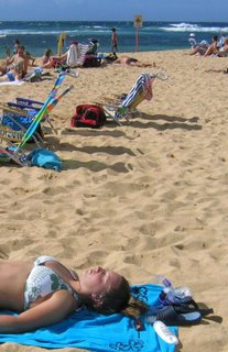 Tanning on famous Poipu Beach, Kauai, Hawaii